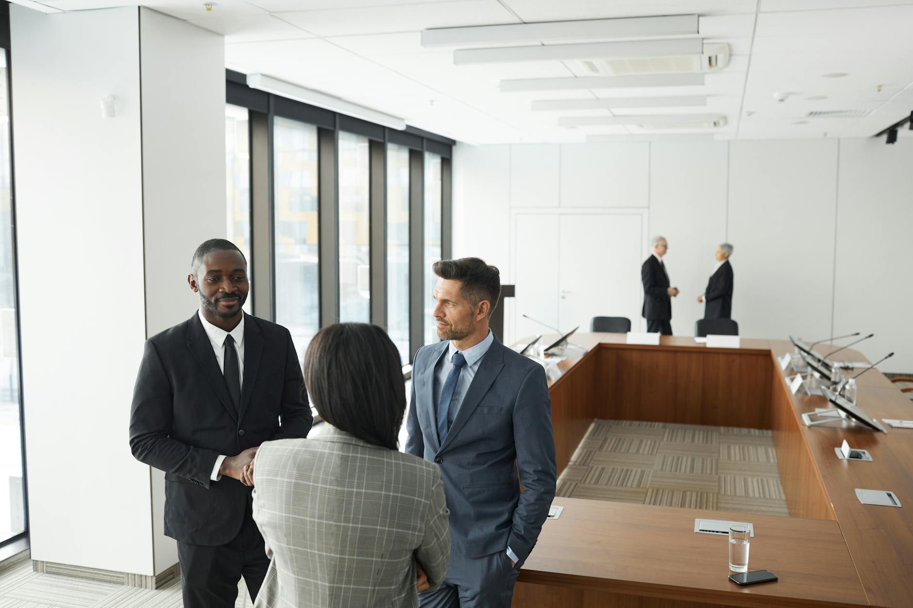Business professionals engaging in a meeting in a modern conference room. — pijushsaha.com