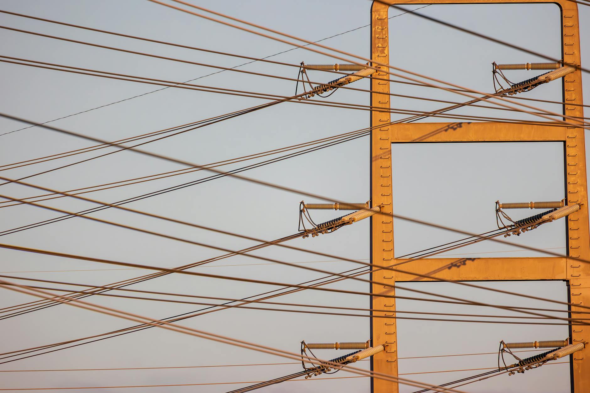 High voltage power lines with sunset sky background, illustrating energy distribution. — pijushsaha.com