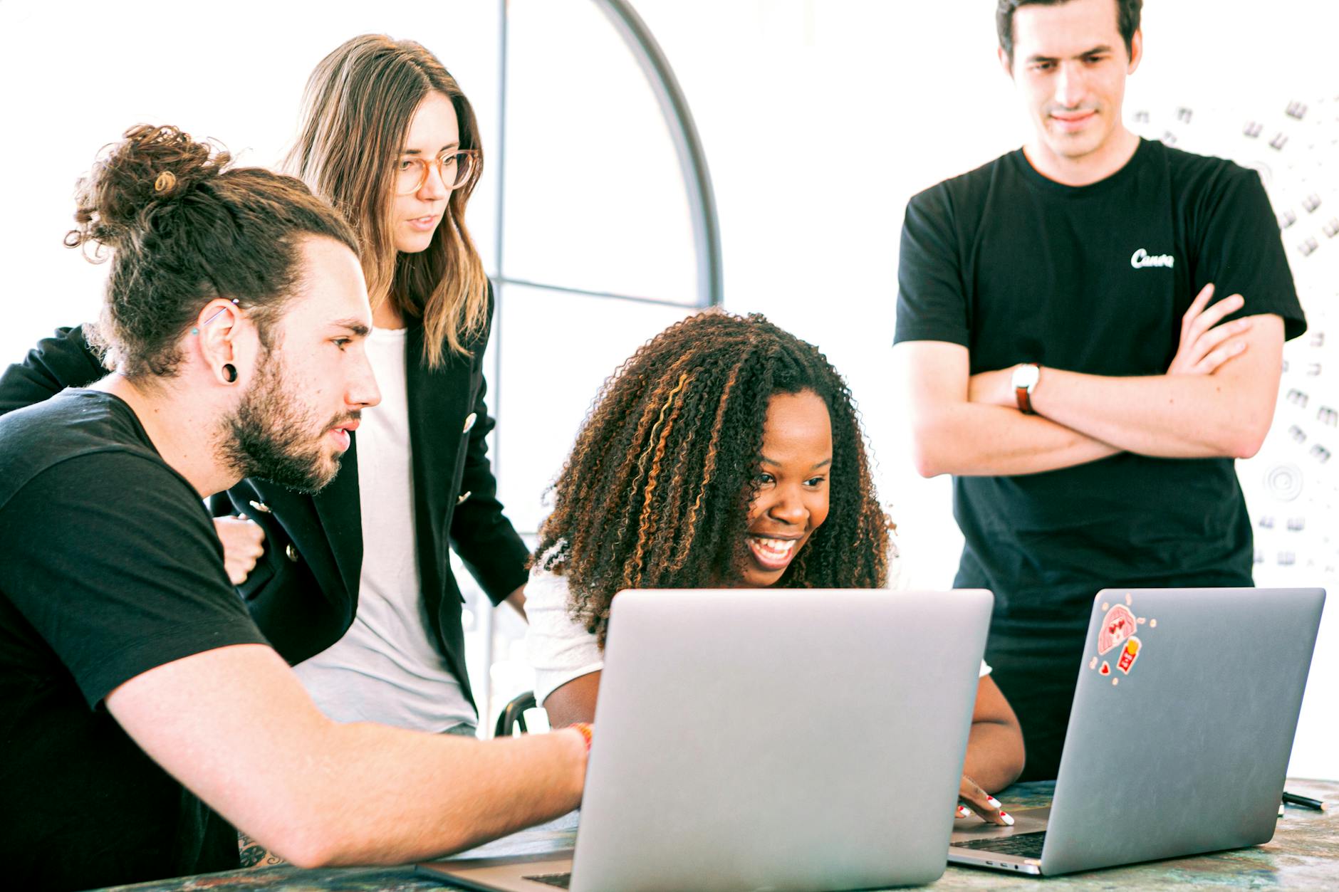 A diverse group of young professionals collaborating enthusiastically in a bright, modern workspace. — pijushsaha.com