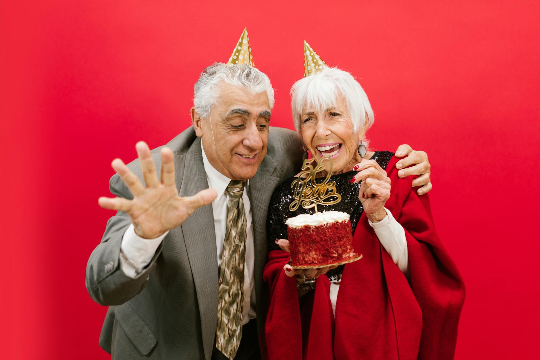 Joyful elderly couple celebrating 60th anniversary with cake and laughter. -- pijushsaha.com