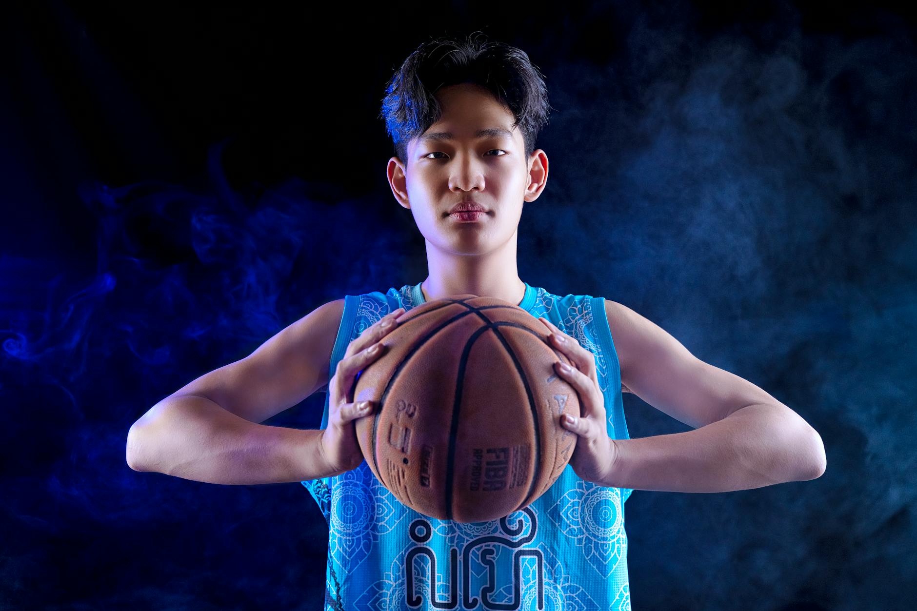 Young basketball player posing in studio with dramatic lighting. -- pijushsaha.com