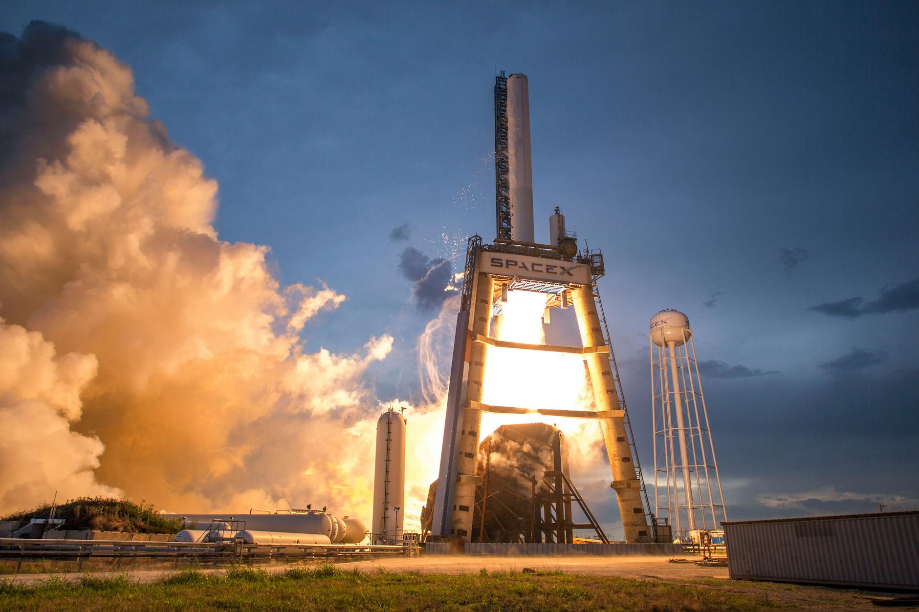 A dramatic shot of a SpaceX rocket launch against a colorful dusk sky, depicting power and technology. — pijushsaha.com