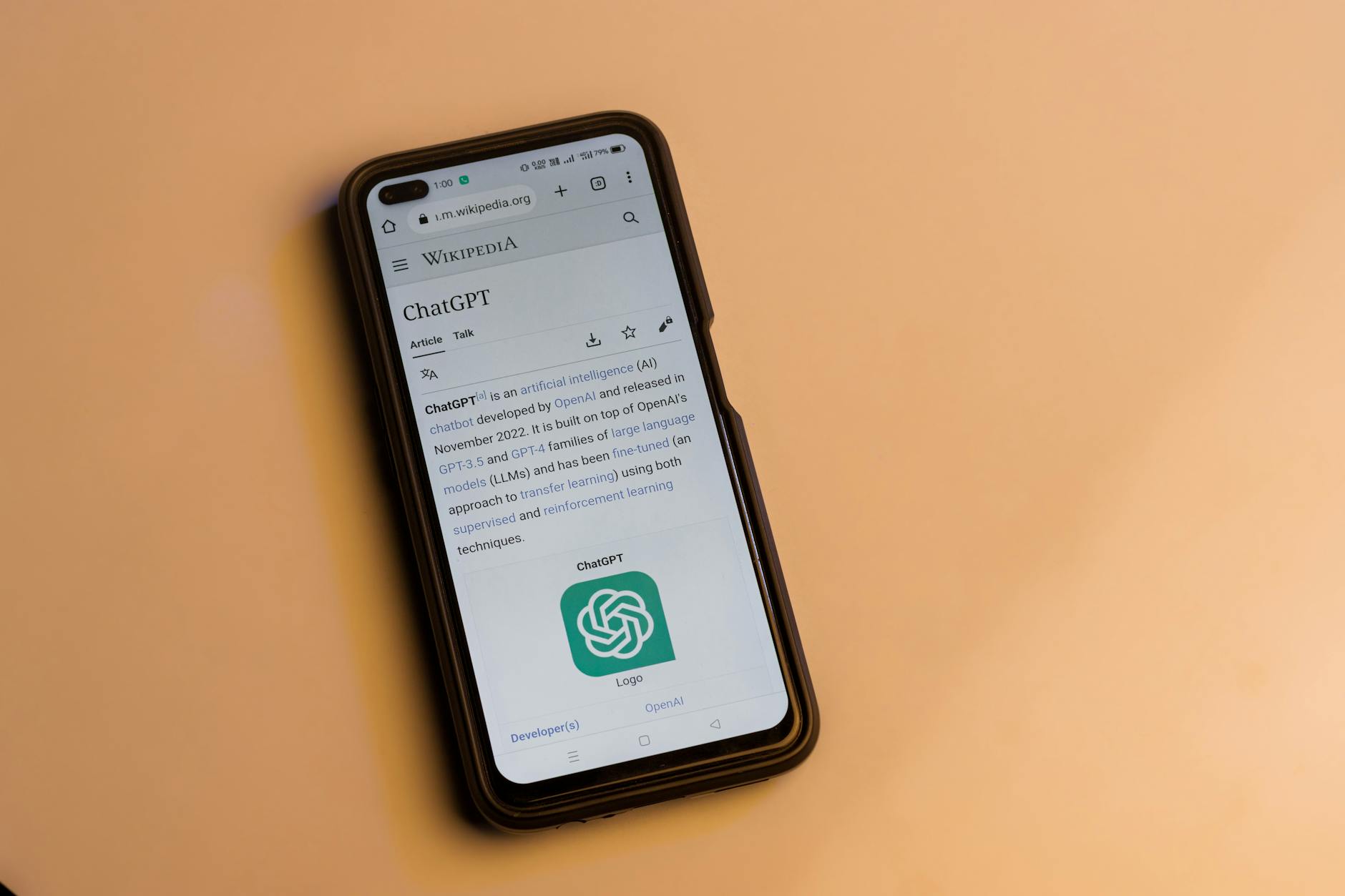 A smartphone displaying the Wikipedia page for ChatGPT, illustrating its technology interface. — pijushsaha.com