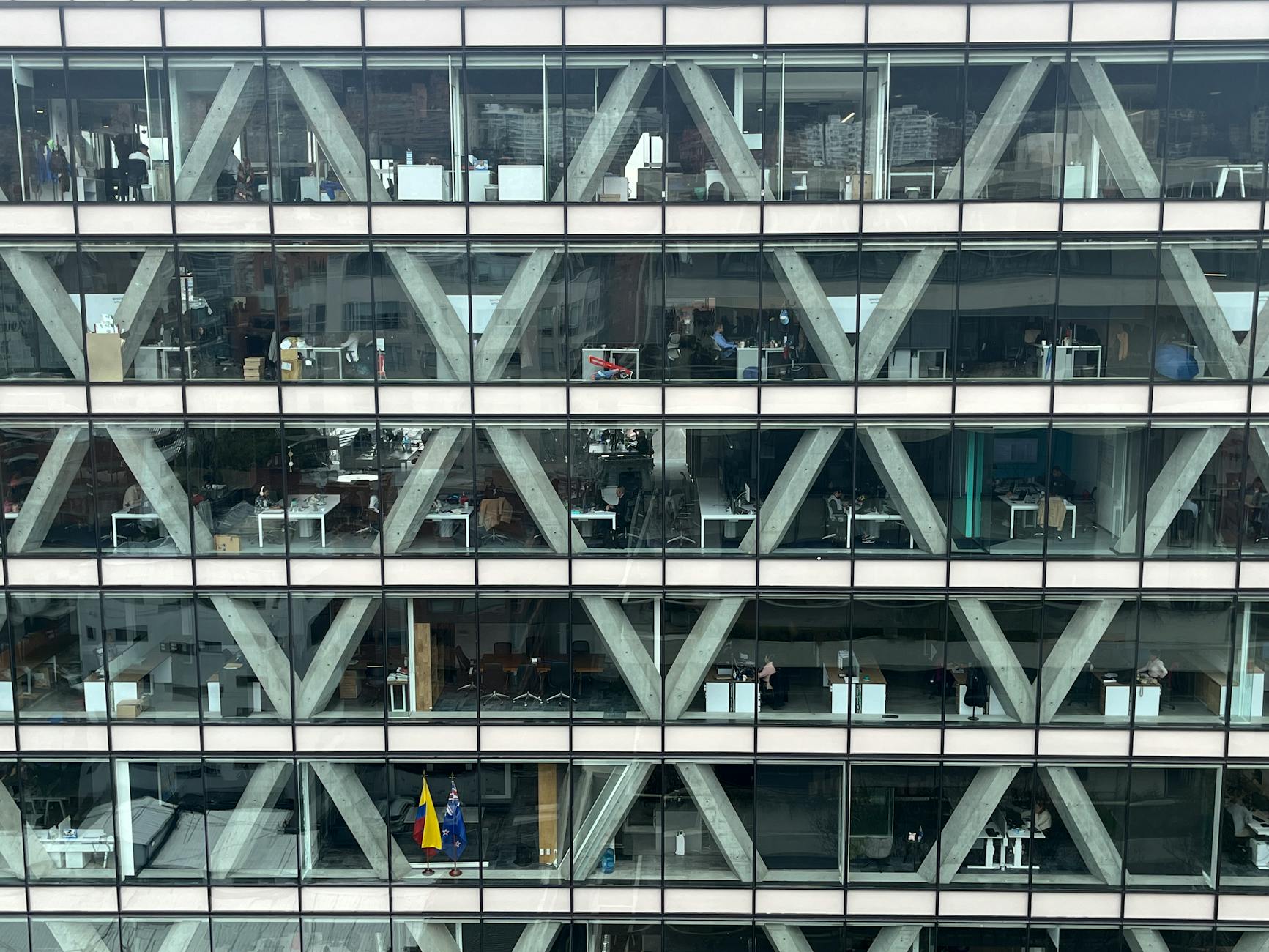 Office building facade with glass windows and geometric patterns in Bogota, Colombia. — pijushsaha.com