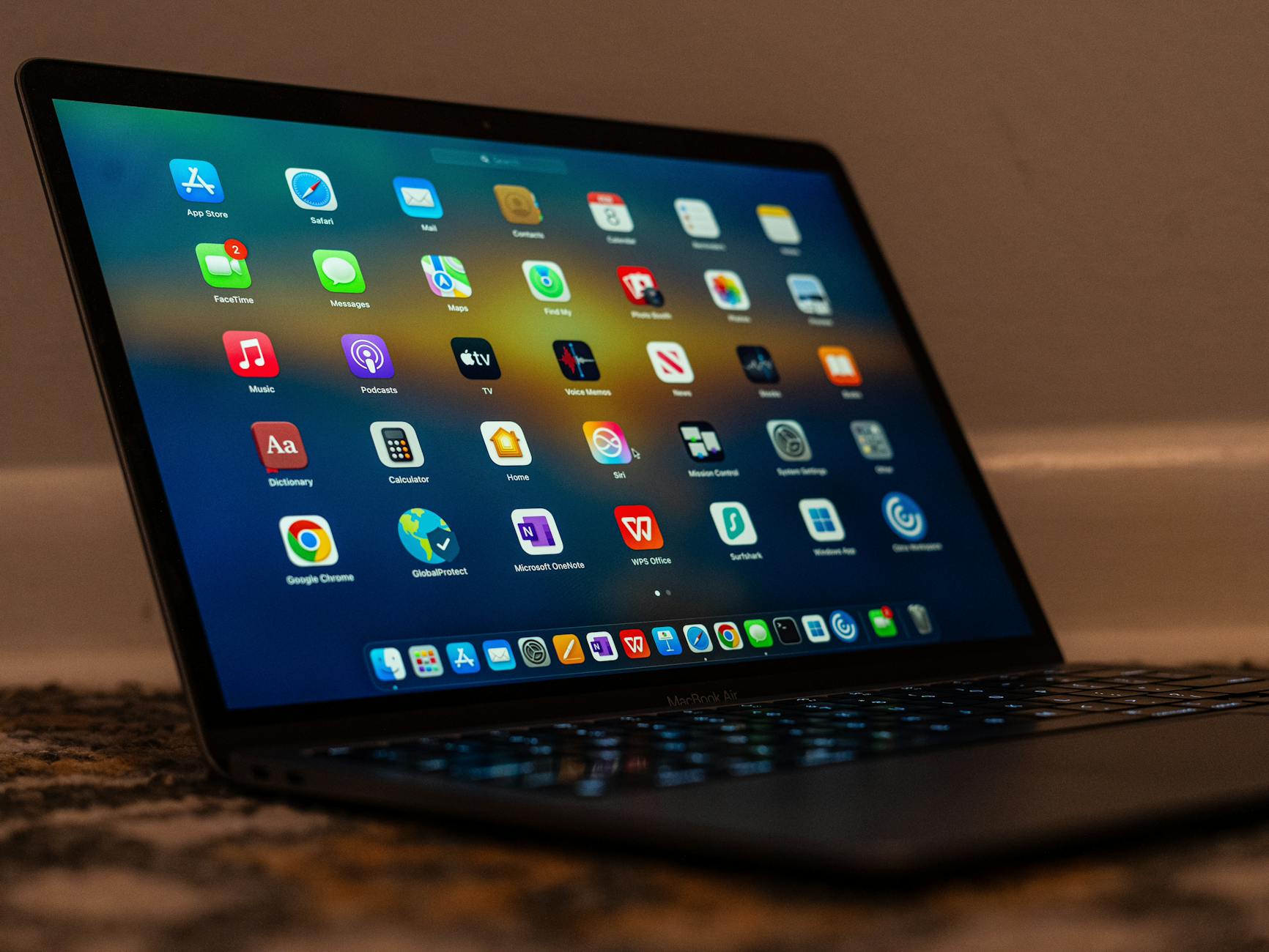 Close-up of a laptop screen showing various applications and colorful icons. — pijushsaha.com