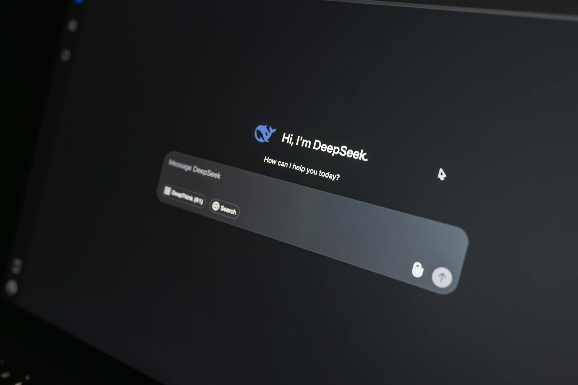 Close-up of DeepSeek AI chat interface on a laptop screen in low light. — pijushsaha.com