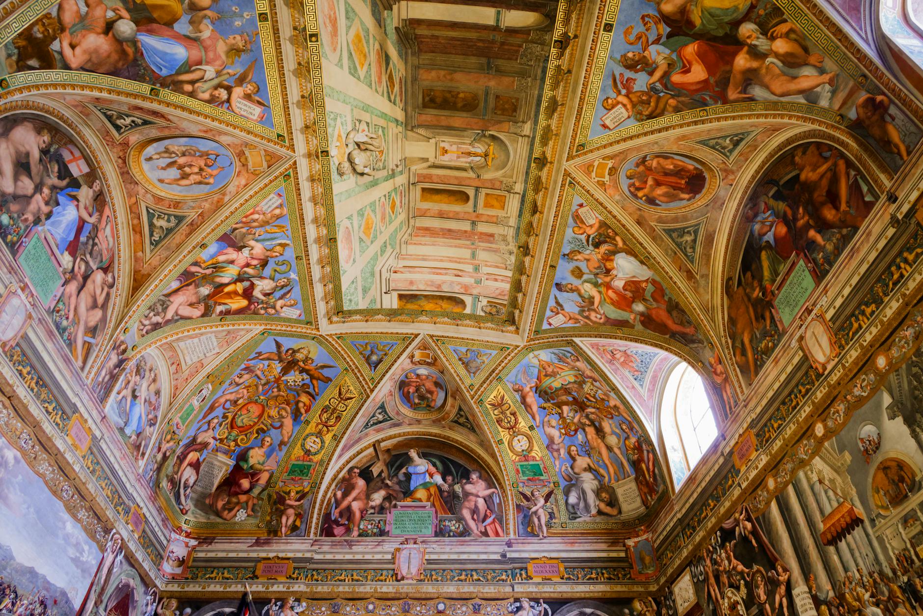 Intricate frescoes adorning the arched ceiling of a historic Roman chapel. -- pijushsaha.com