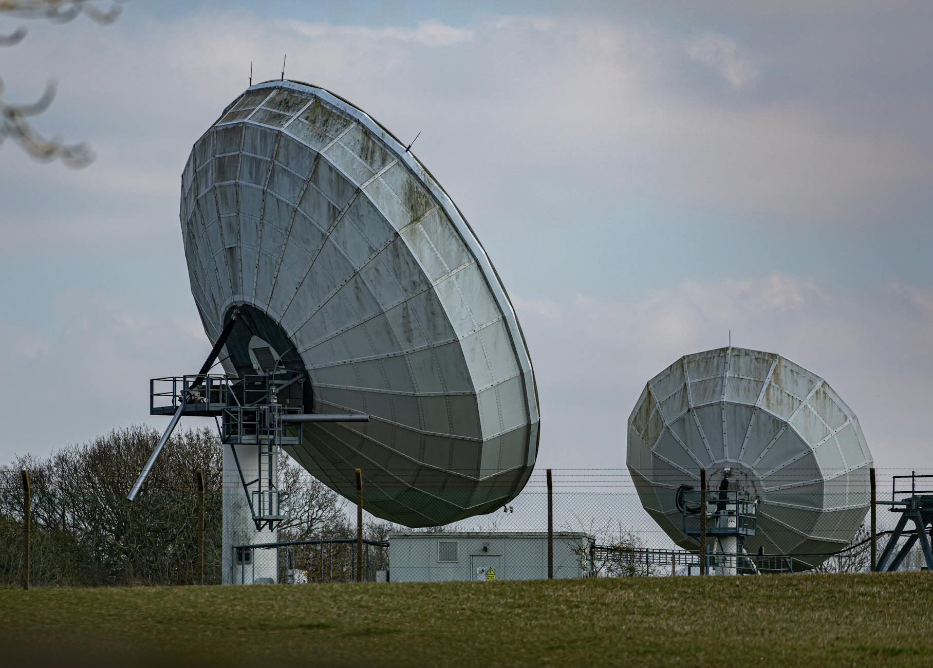 Two large radio telescopes in an outdoor setting, showcasing astronomy and science technology. — pijushsaha.com