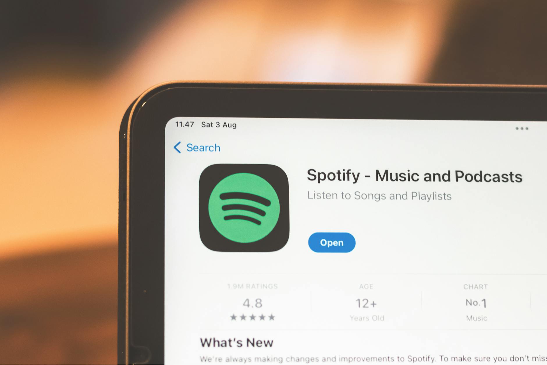 Close-up of Spotify app page displayed on a tablet screen, highlighting its features. — pijushsaha.com