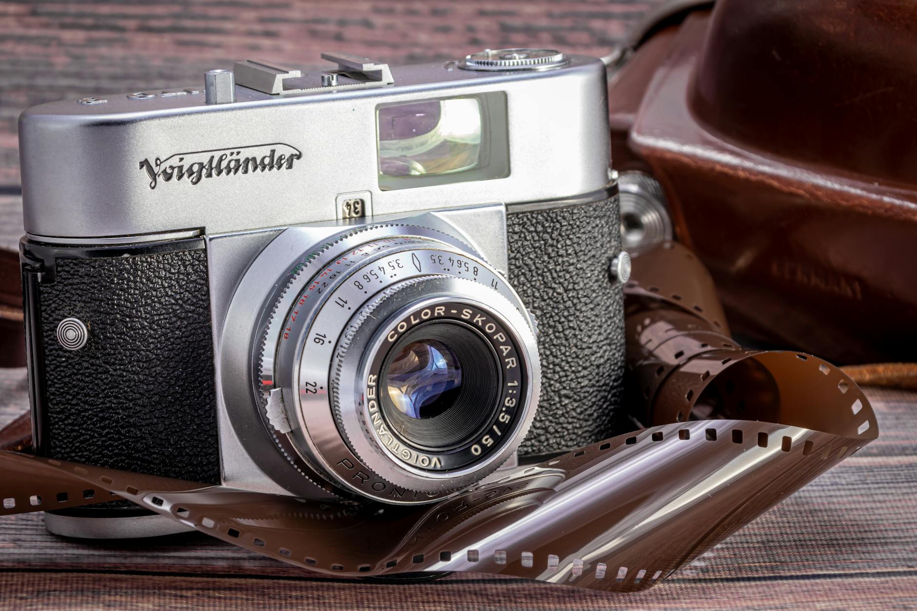 Close-up of a vintage Voigtländer film camera with an unwound film reel, evoking classic photography. -- pijushsaha.com