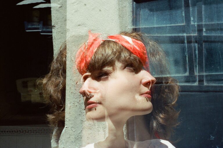 Artistic double exposure portrait of a woman with red bandana, blending perspectives. -- pijushsaha.com